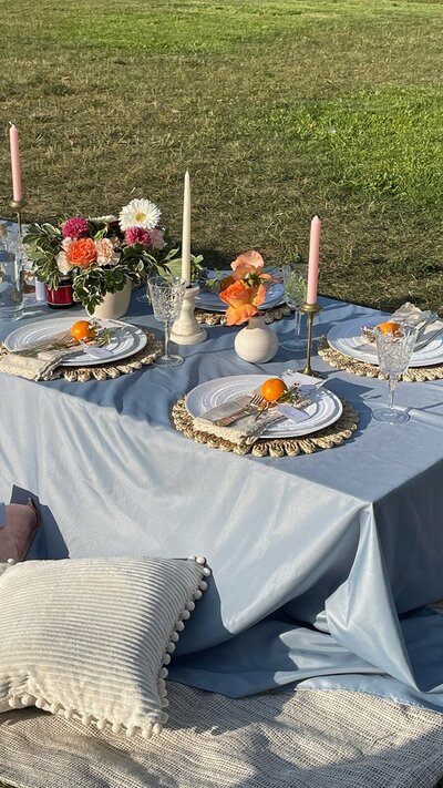 Elegant outdoor tablescape with pastel linens, colorful florals, and citrus accents, styled by Yours Truly, a wedding planner and designer in New Jersey.