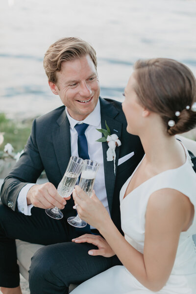 bride and groom cheers champagne on wedding day