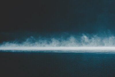 Image of a dark sky over the ocean representing darkness of trauma