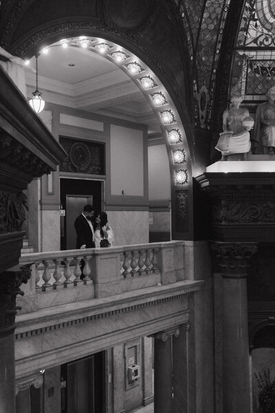 Bride and groom eloping in historic courthouse, cinematic black and white wedding photography by Tarah Shea