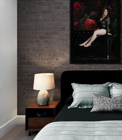 Image of a bedroom with a framed photo of a woman during her boudoir photography session