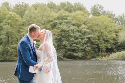 Bride and groom share a kiss during private vows at the Sugar Tree Lodge in Ligonier Valley, captured by Lens Love Photography