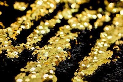 close up of a black and gold sequin backdrop