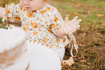 Six month old baby boy smiling at the camera, dressed in white