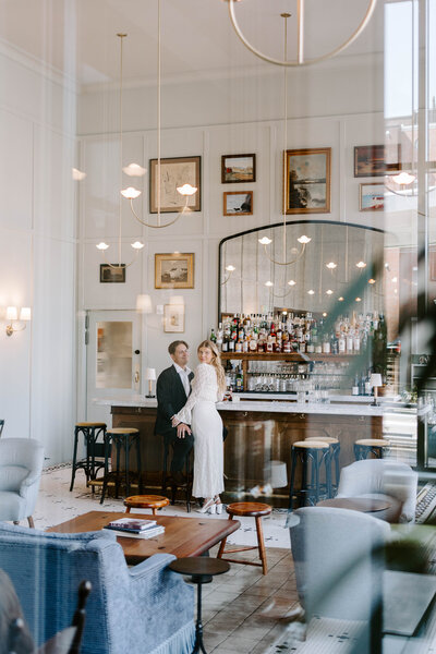 Photo of bride and groom standing in hotel lobby taken by documentary wedding photographer Portland Maine