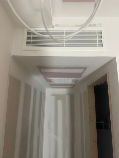 Photo of a ducted air conditioning system integrated into the ceiling, ideal for discreet and efficient cooling in larger spaces.