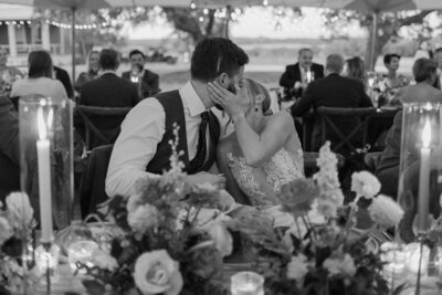 wedding in texas - bride and groom kissing at the reception during toasts