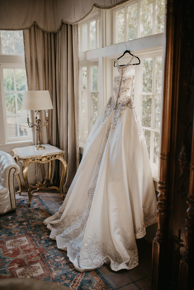 Wedding dress hanging in the window, Marlsgate Plantation Little Rock Arkansas Wedding