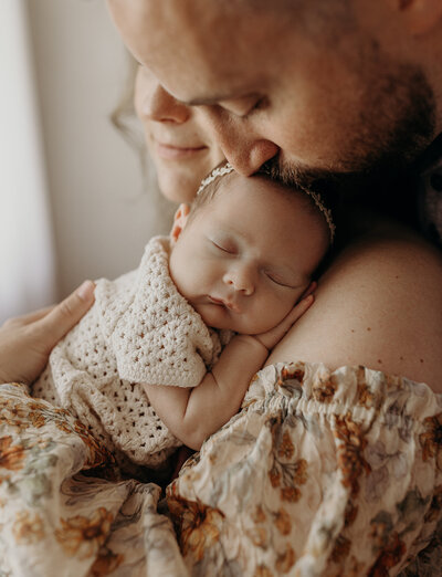 Toddler holding her newborn baby sibling in the Rancine Business Center Studio.