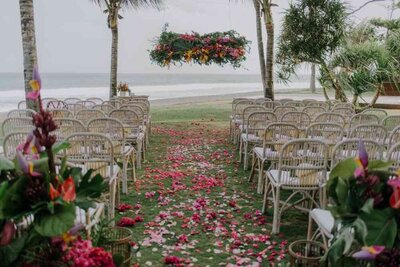 beautiful rose petals and hanging flower installation at oceanside wedding ceremony in Bali