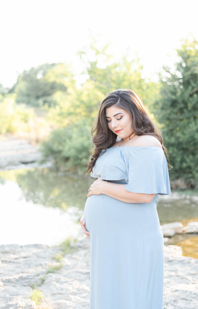 pregnant woman holds her baby bump