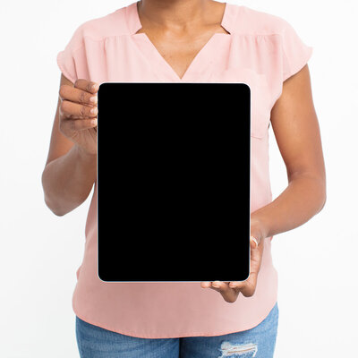A woman in a blush top holds a tablet displaying a Website Audit Checklist—offering a free download to boost site performance.