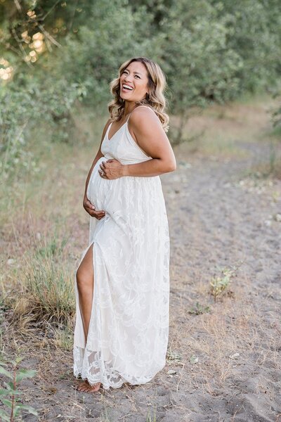 mom in white dress for maternity photo session