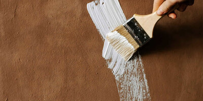 patio furniture with tile table and rattan chairs at sunset