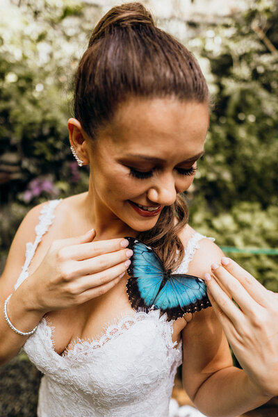 bride holding blue butterfly