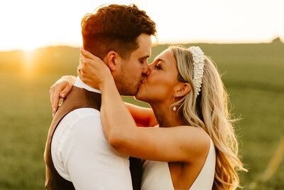 bride wearing white lace dress hugging groom both with huge smiles fun aberdeen wedding photography