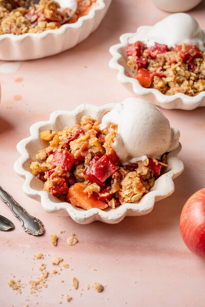 a gluten free dessert made with apples and rhubarbs, topped with vanilla ice cream