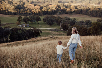 Mum-holding-her-sons-hand-walking-together-down-huon-hill