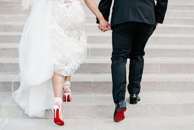 couple holding hands and umbrellas