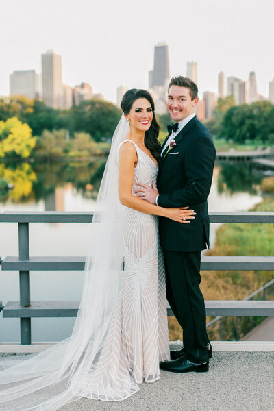 A timeless wedding portrait of a bride and groom standing together in an elegant Chicago venue, captured in soft natural light.