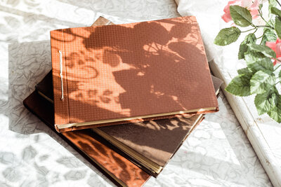 old-brown-photo-albums-are-stacked-on-the-table-by-2023-11-27-05-11-40-utc