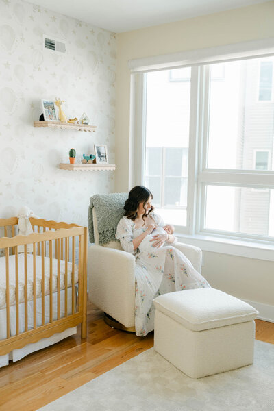 Newborn baby in mother's arms in a bright Delaware nursery