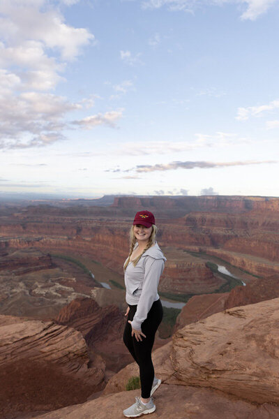 Moab elopement photographer, Forever Framed by Rachel, in front of a canyon in Utah.