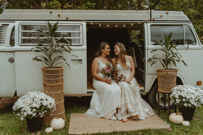 brides sitting in white vw van