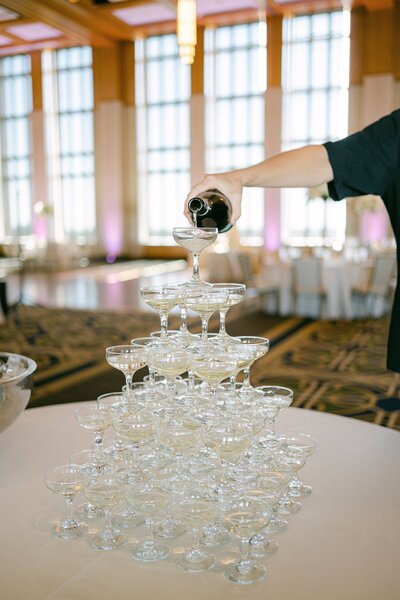 Champagne pour in a tour of coupe glasses at a wedding reception on the campus of the University of Notre Dame