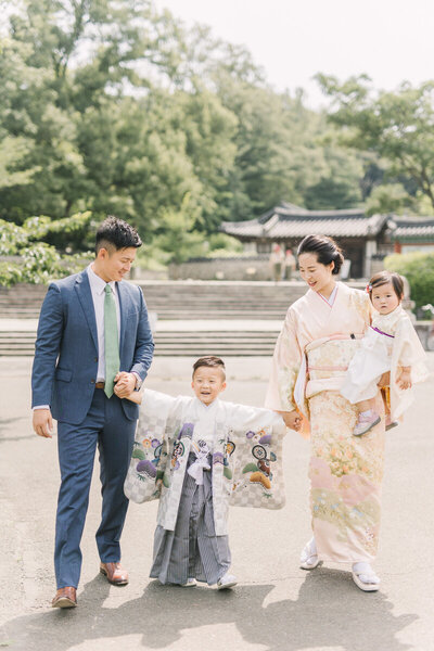 港北区で撮影した七五三の前撮り撮影。五歳の男の子が袴を着て、ママとパパと手をつないで笑っている姿が可愛い家族写真。