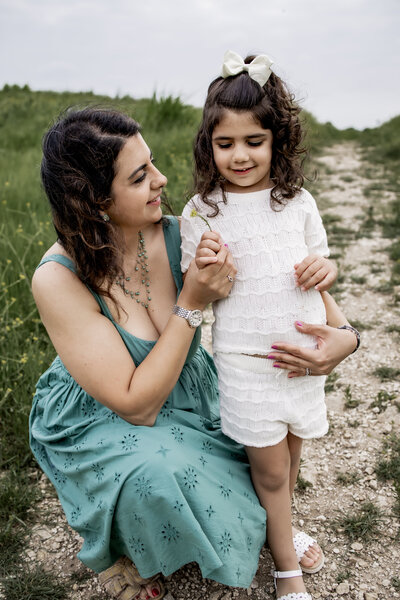 mom and daughter look at wild flowers in Plano Texas at Arbor Hills