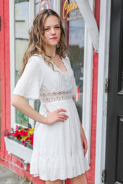 Girl standing in front of red building with hand on hip | Senior Session