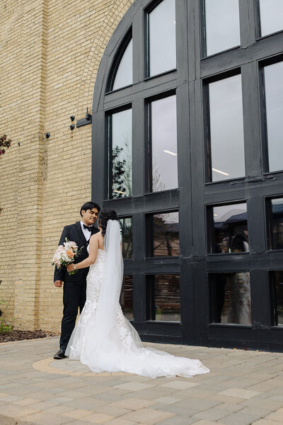bride and groom in courtyard at venue