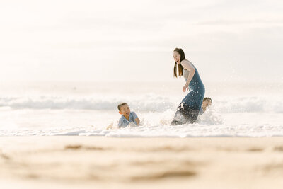 Candid playtime in the water of young kids and family in Sydney beach, joyful natural photography