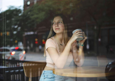 Senior portrait of a girl sitting in  Starbucks in downtown Erie Pa