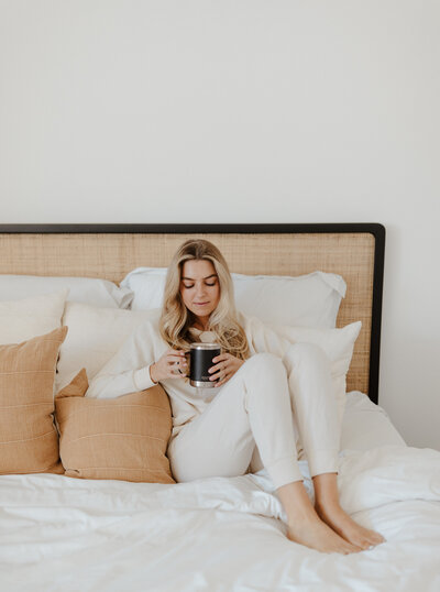 girl sitting in bed holding asobu mug in San Diego, CA