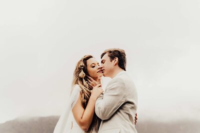 groom kisses bride on cheek at charlotte ceremony