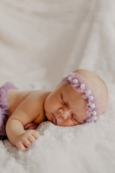 Baby looks at parents in photo taken by Loveland Newborn Photographer