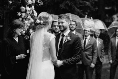 Bride and groom in wedding ceremony on a rainy day