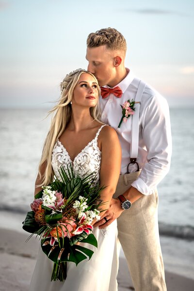 Just married couple posing on Bradenton Beach at Sunset