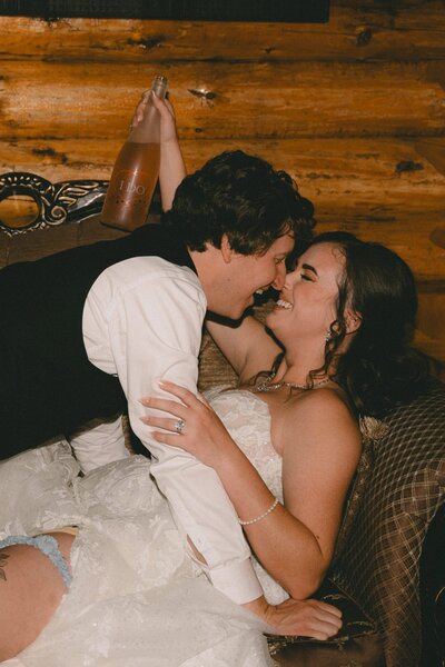 Wedding couple lying on the couch and nearly kissing