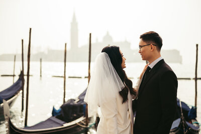 A captivating scene as the couple gazes into each other's eyes, embracing the enchanting charm of Venice's iconic square amid the winter serenity