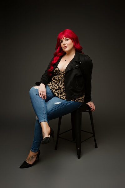 Woman with vibrant red hair poses for brand photos
