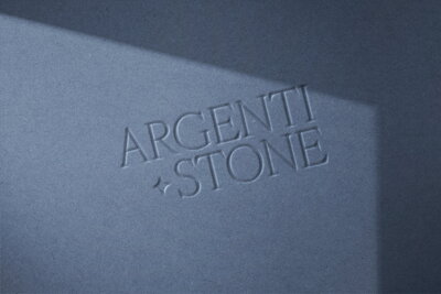 Embossed logo design mockup featuring elegant typography on textured blue paper — brand identity created by Almost Always.