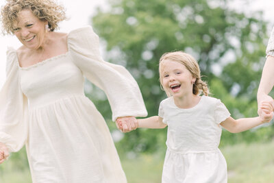 smiling granddaughter holding grandmother's hand