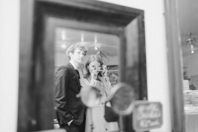 Wedding guest Peyton Curry, a film wedding photographer, capturing a candid moment on film during an intimate Richmond, Virginia backyard wedding reception.