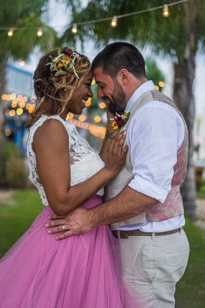 Profile of bride and groom embracing each other after their wedding ceremony