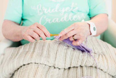 crocheting volunteer makes stillborn miscarried baby bereavement memorial cradles