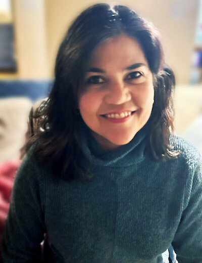 portrait of polly banerjee wearing green sweater