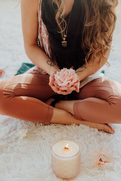 Luna Skye holding flower in hand with candle
